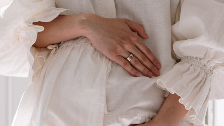 a pregnant woman in white dress